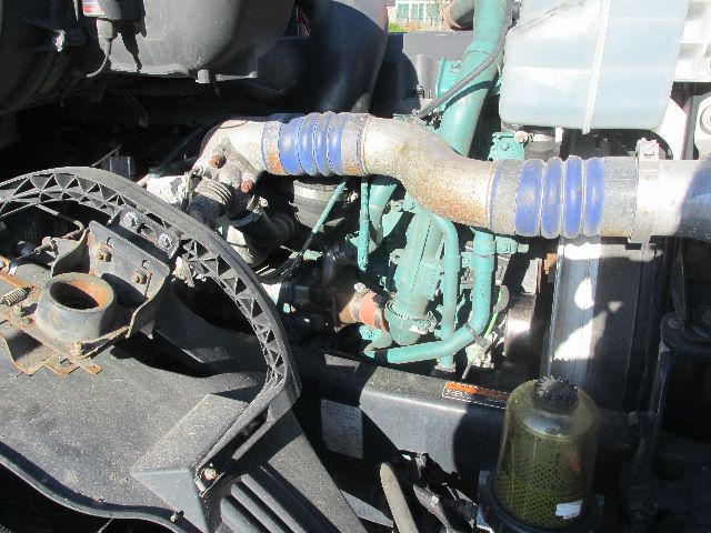 Volvo engine bay showing coolant hoses, turbo and various engine components in a sleeper truck.