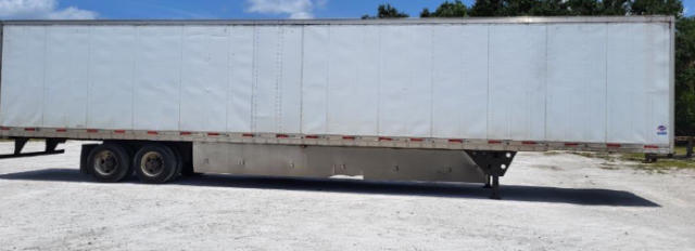 Utility trailer side view showing a long rectangular white cargo body on dual rear axles with a front landing gear and a raised black bar undercarriage.