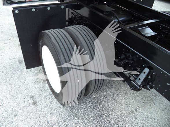 Isuzu NPR HD truck rear dual wheels and frame showing chassis with black components.