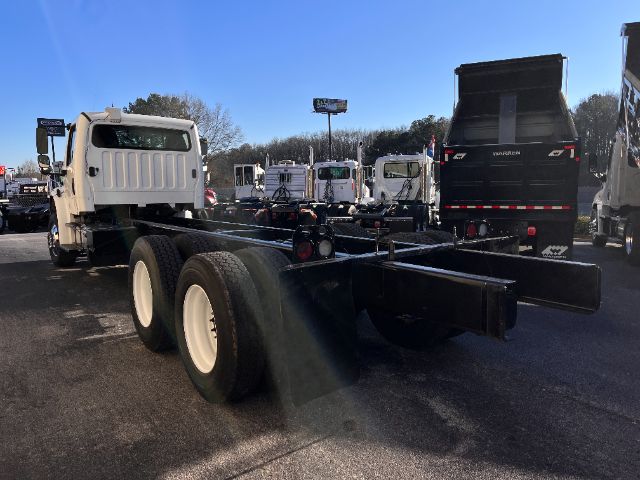 Freightliner M2 cab and chassis rear view showing dual rear axles and chassis rails.