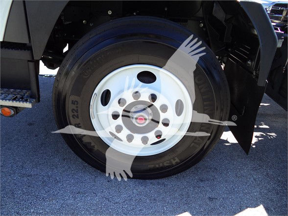Isuzu FTR wheel and tire assembly showing steel wheel and tire piece in the front of a tow truck.