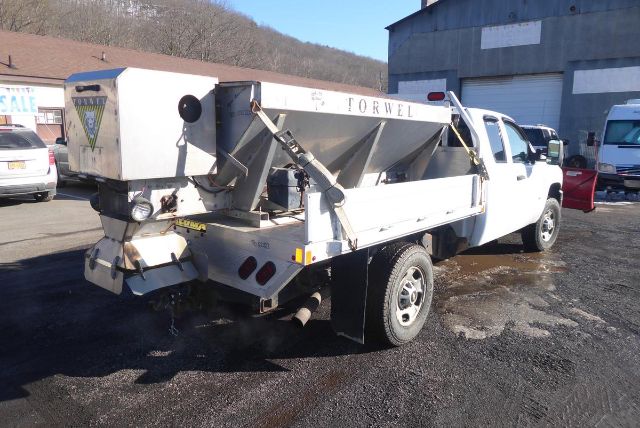 2011 Chevrolet 2500HD dump truck rear quarter view showing dump bed with FORWEL label and hitch area.