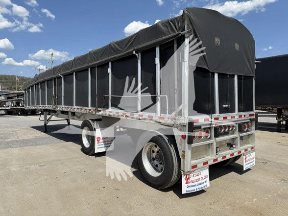 Trailer showing a covered flatbed with black tarp and rear equipment; appears to be a 2022 Reitnouer Big Bubba trailer.