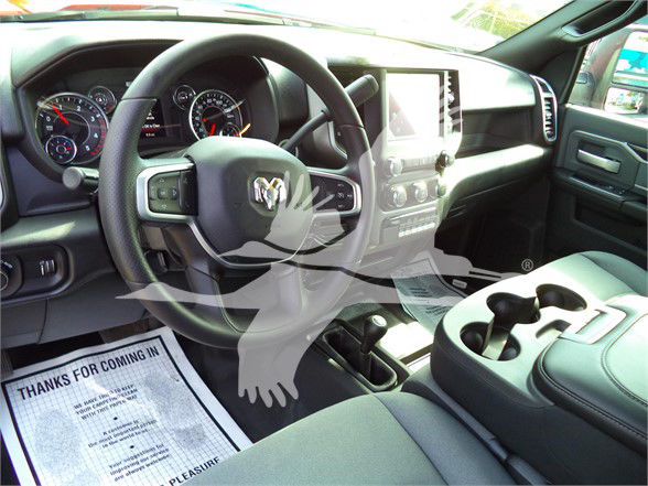 Ram 5500 interior showing steering wheel, center console with touchscreen, and cup holders.