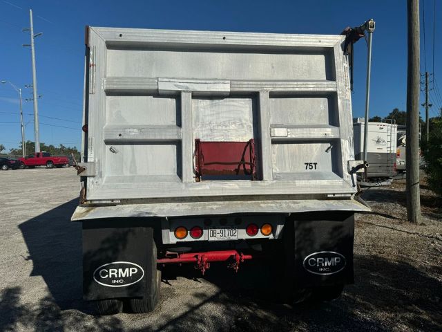 Dump trailer rear showing tailgate with 75T marking and CRMP mud flaps.