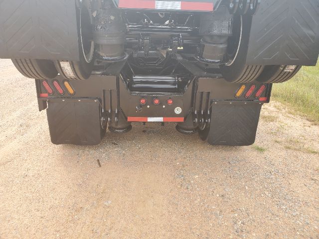 Atoka 2020 RGN-553-S lowboy trailer rear view showing mud flaps, dual rear axles and kingpin area with hydraulic components.