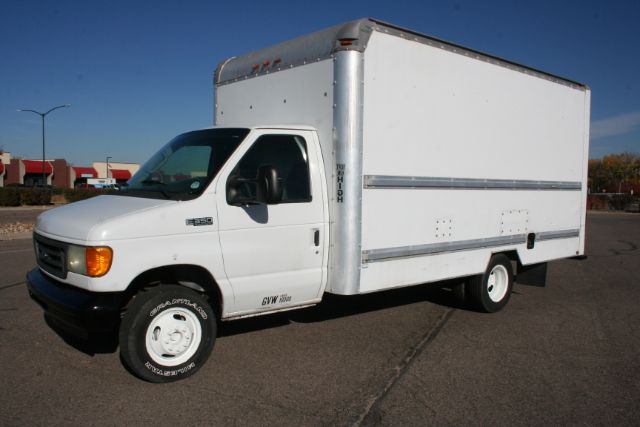 2005 Ford E350 box truck in white with a square box cargo area, front cab visible, side view shows box with aluminum trim