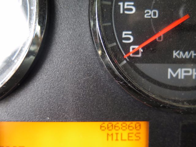 Truck instrument cluster gauge and odometer displaying 606860 miles in an orange digital display area.
