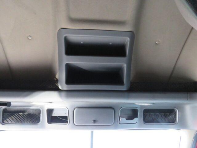 Cab overhead storage compartments in Freightliner Cascadia Evolution interior showing two rectangular shelves.