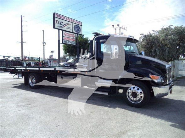 Kenworth T280 tow truck side view with flatbed, chrome wheels, and black cab. Stock number KWT280XLP22 in a dealership lot.