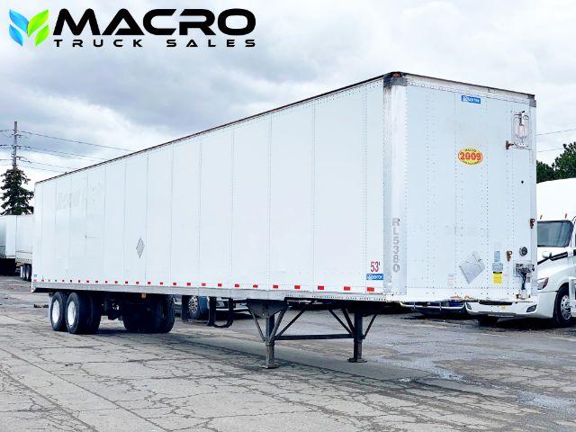 2009 Stoughton dry van trailer showing MACRO Truck Sales watermark; white rectangular trailer with dual rear doors, landing gear, and tandem wheels.