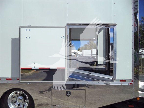 Truck body with rear side door open showing interior cargo area and mounted storage drawer.