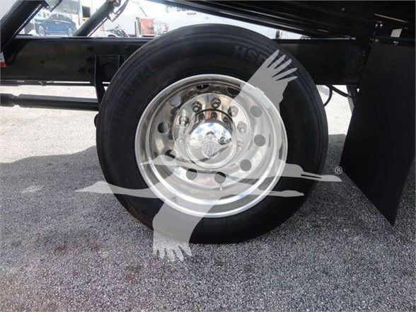 MV607EXCAB22XLP wheel showing polished steel rim and black tire on International MV series truck trailer assembly.