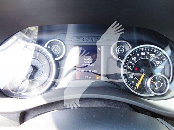 Ram 4500 dashboard gauges with speedometer and tachometer, center display showing a message, interior view