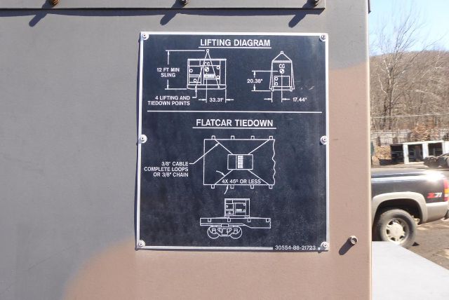 MEP-804A lifting diagram plate showing lifting diagram and flatcar tiedown with text labels on a gray truck equipment surface.