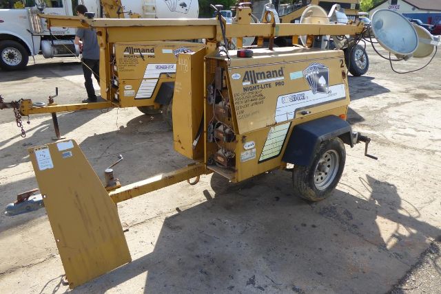 Allmand Night Lite Pro light tower/trailer unit in a yellow chassis with branding, mounted on a single-axle trailer, showing labels and control panels.