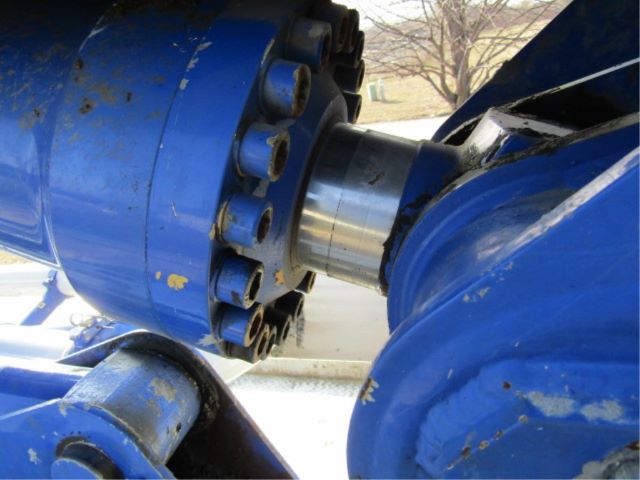 Mack T310M chassis joint with blue components and large hub, showing bolted connection and metal sleeve.