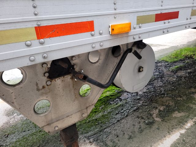 Trailer rear undercarriage showing support frame and suspension components of a utility trailer.