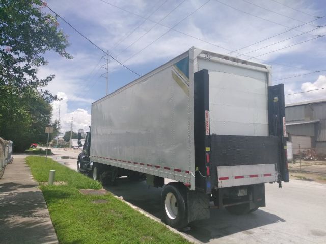Box truck/trailer with cargo box in a street, rear lift gate, side is blank, used condition.
