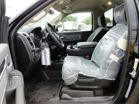 Ram 4500 SLT interior showing front seats with plastic covers, steering wheel, center console, and door panel.