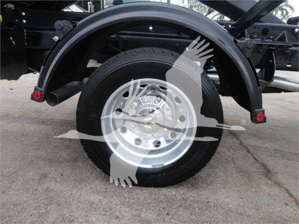 Ram 5500 SLT wheel and fender area with black frame and wheel well, showing rear wheel and hub, stock image with watermark overlay.