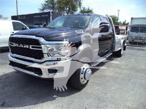 2023 Ram 5500 SLT truck in a lot showing front grille with RAM lettering and dual rear wheels visible.