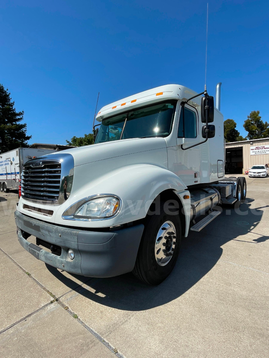 Freightliner Columbia 120 cab and chassis shown in white with chrome grille and dual side mirrors.