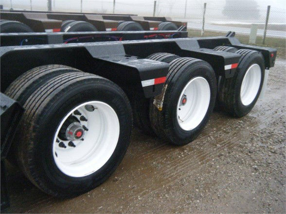 Talbert 55SA flat deck HRG trailer showing triple-axle with white wheels and black frame.