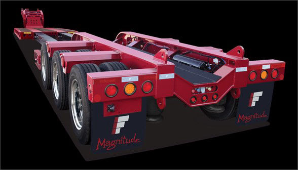 A red Fontaine Magnitude trailer chassis with multiple axles in a 3/4 rear view showing wheels and frame.