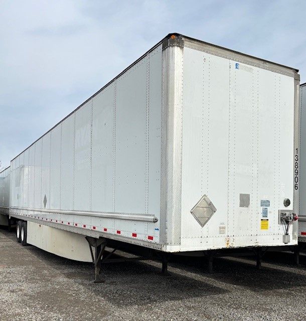 Trailer side and rear view of a 53' Stoughton dry van trailer with white exterior, front landing gear visible, and rear doors.