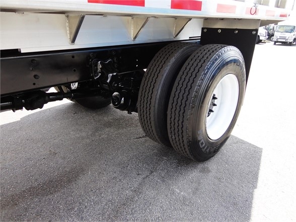 Freightliner Business Class M2 106 wheel and chassis view showing dual rear tires and undercarriage, with white rim and black frame.