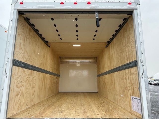 Box truck cargo area showing plywood walls and floor with E-track rails along sides.