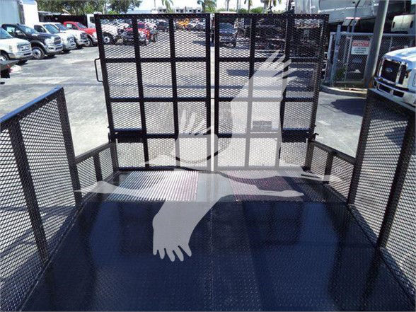 Flatbed truck rear with metal mesh sides and tailgate. View shows painted floor surface and gate panels.