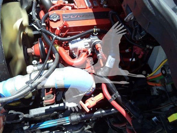 Engine bay with orange International/DURASTAR 4300 engine, visible hoses, wiring, and components.