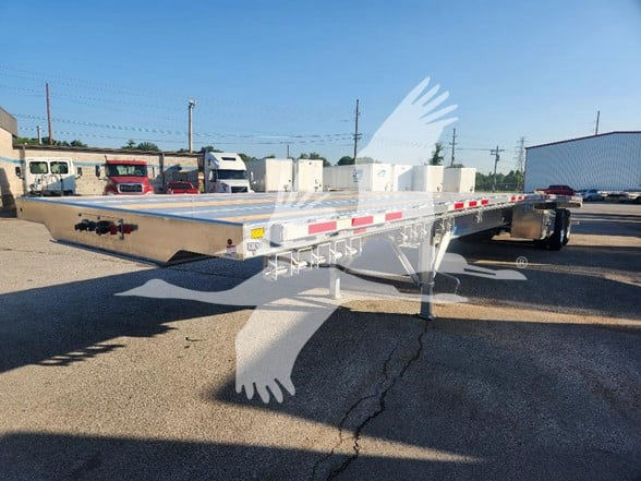 Flatbed trailer show side view with aluminum deck and dual rear axles, gooseneck area visible, reflective safety tape along sides.