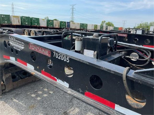 Lowboy trailer side frame with Fontaine branding and stock number 702005, showing circular access holes and structural beams.