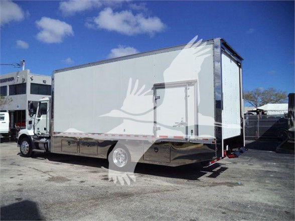 Box truck with a closed cargo trailer attached to a Mack MD6 tractor. Side shows no legible text; the rear ramp door is open.