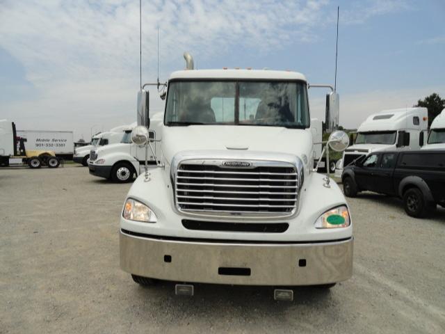 Front view of a white 2009 Freightliner Columbia conventional daycab truck with large grille and bumper.