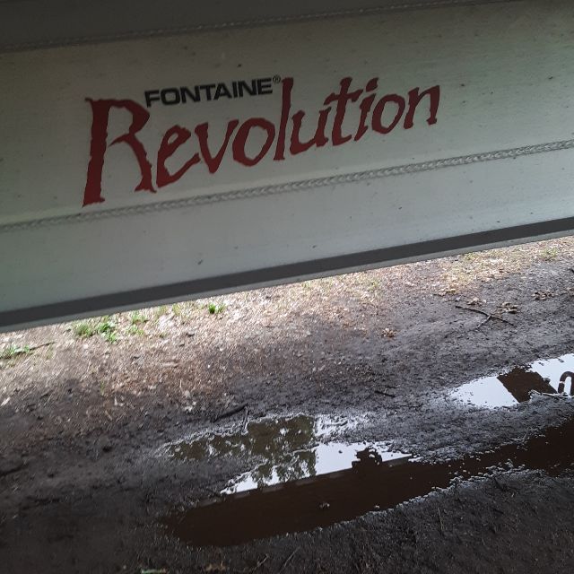 Fontaine Revolution 52 trailer side panel with 'Revolution' script and Fontaine branding visible.