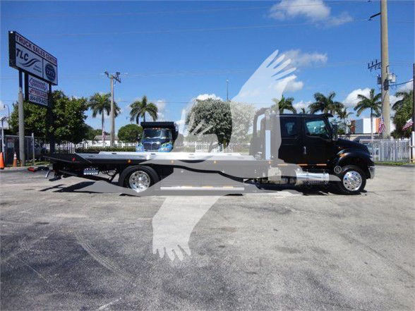 Tow truck with a long flatbed on a black cab chassis, International MV model, VIN 1HTEUMML7NH043803 visible in listing, stock J43803.