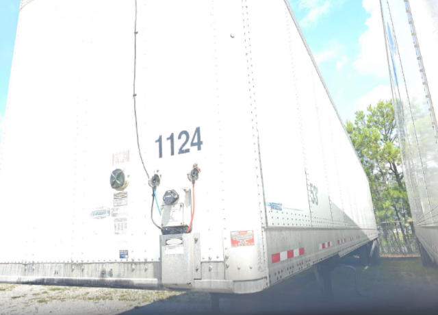 Trailer rear corner showing '1124' marking and electrical connections on a white Vanguard VXP trailer.