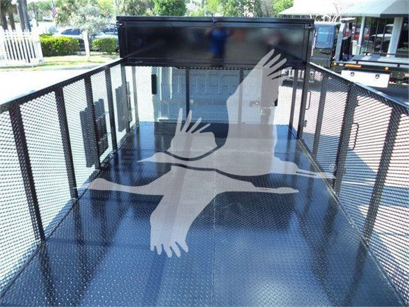 Isuzu NPR HD truck bed with black metal railing and diamond plate floor, view from inside cargo area.