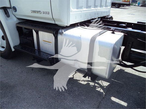 Truck side showing fuel tank and chassis undercarriage of a 2016 Hino 268A dump truck.