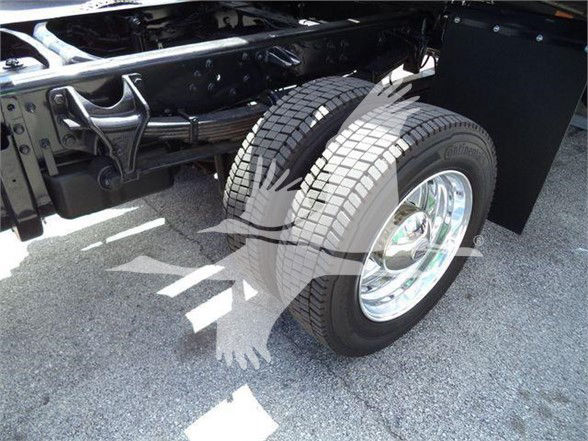 Dual rear wheels of a heavy truck chassis with chrome rims and visible frame components.