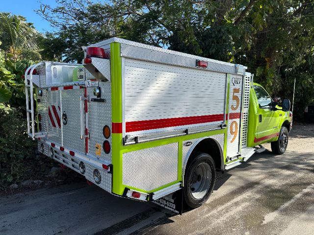 Ford utility rescue fire truck in bright lime green with white compartments and red reflective stripes, side panel with '5' '9' numerals.