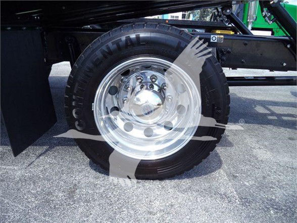 Kenworth T280 wheel area showing dual rear tires and chrome wheel with polished hubcap.