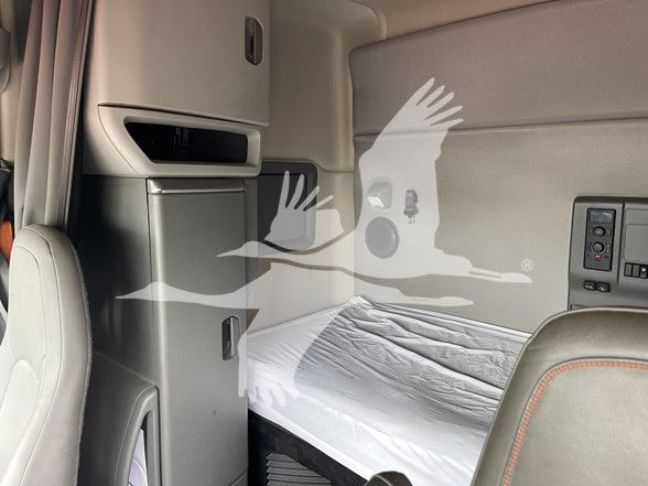 Volvo VNL64T740 truck sleeper cab interior with bunk bed and storage cabinets visible.