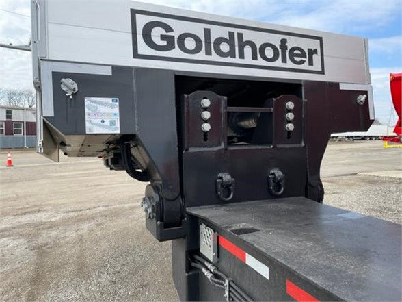 Goldhofer trailer hitch area with drop deck and logo, side view showing pins and coupling area.