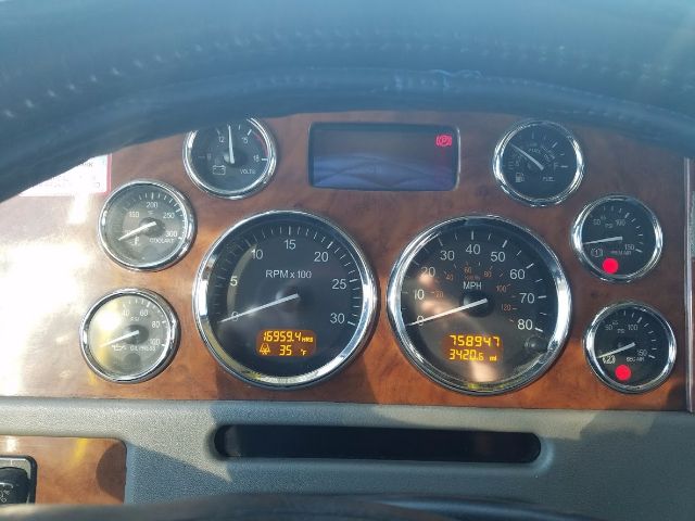 Peterbilt 389 gauge cluster and wood grain dashboard with multiple analog meters and digital displays visible