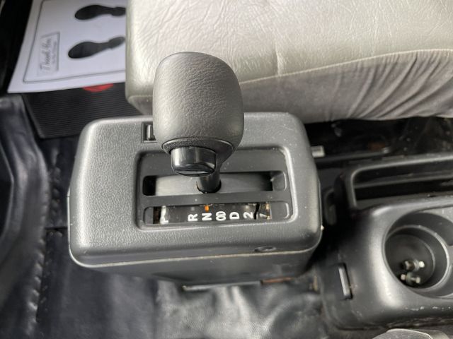 Gear selector showing shift pattern P R N D 3 2 1 in a Hino 268 box truck interior.